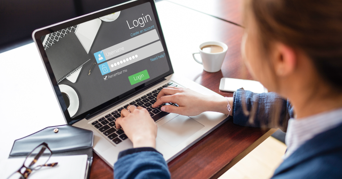 Woman at desk with a laptop looking at login screen