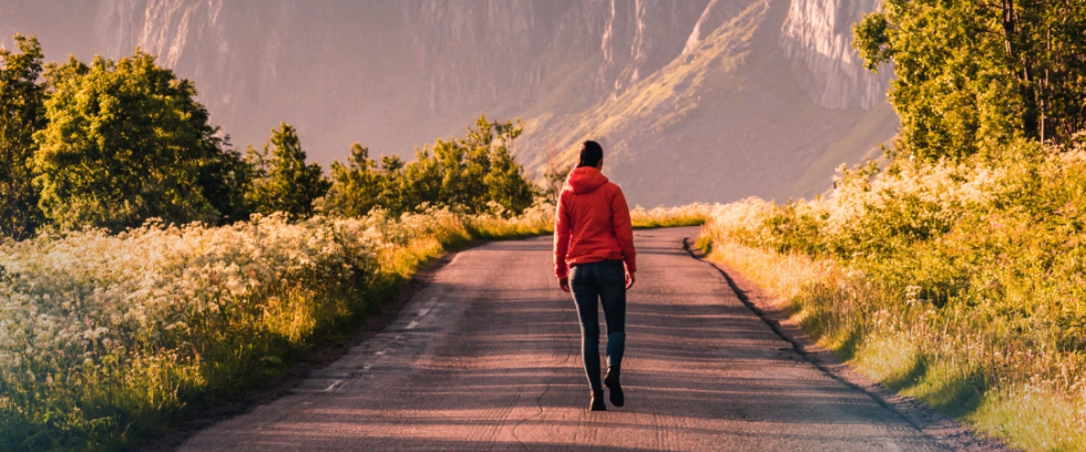 Woman walking on a path with a scenic view