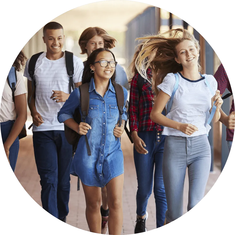 adhd-testing Group of teens walking down the hallways at school smiling